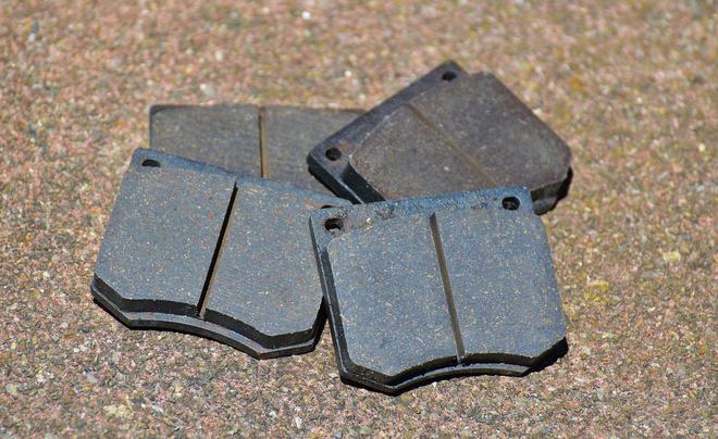 Worn brake pads close-up before replacement