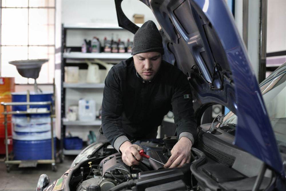 Mechanic carrying out an oil change and car service