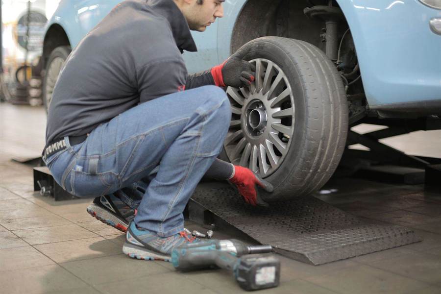 Mechanic carrying out a general car service check